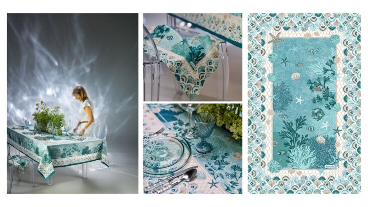 Nappe Beauvillé Récif coloris mer avec motif marin coraux et coquillages, table dressée avec vaisselle et verre bleu dans une ambiance inspirée des fonds marins.