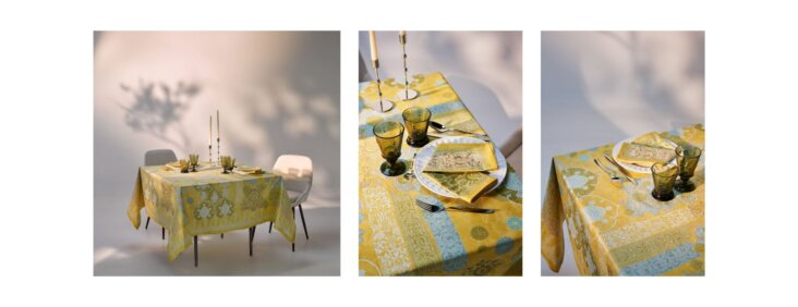 Nappe Beauvillé Rialto coloris citron vert sur une table dressée avec verres et bougies, motif décoratif élégant dans des tons jaunes et verts.